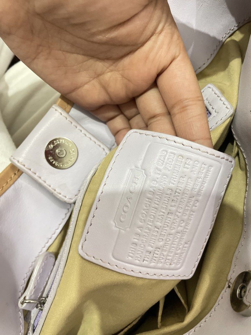 Coach Lavender & Cream Leather Shoulder Bag (Category: Luxury Bags & Wallets) located in Manila. Submitted by epicwhale-cd67 (Listing ID 1461427032, Image 3). Description: - Authentic Coach shoulder bag - Lovely lavender and cream color - Made from genuine leather - Interior zip pocket for essentials - Secure magnetic snap closure - Adorable daisy charm included - Perfect for daily use - Shows some signs of wear, but still in great usable conditi