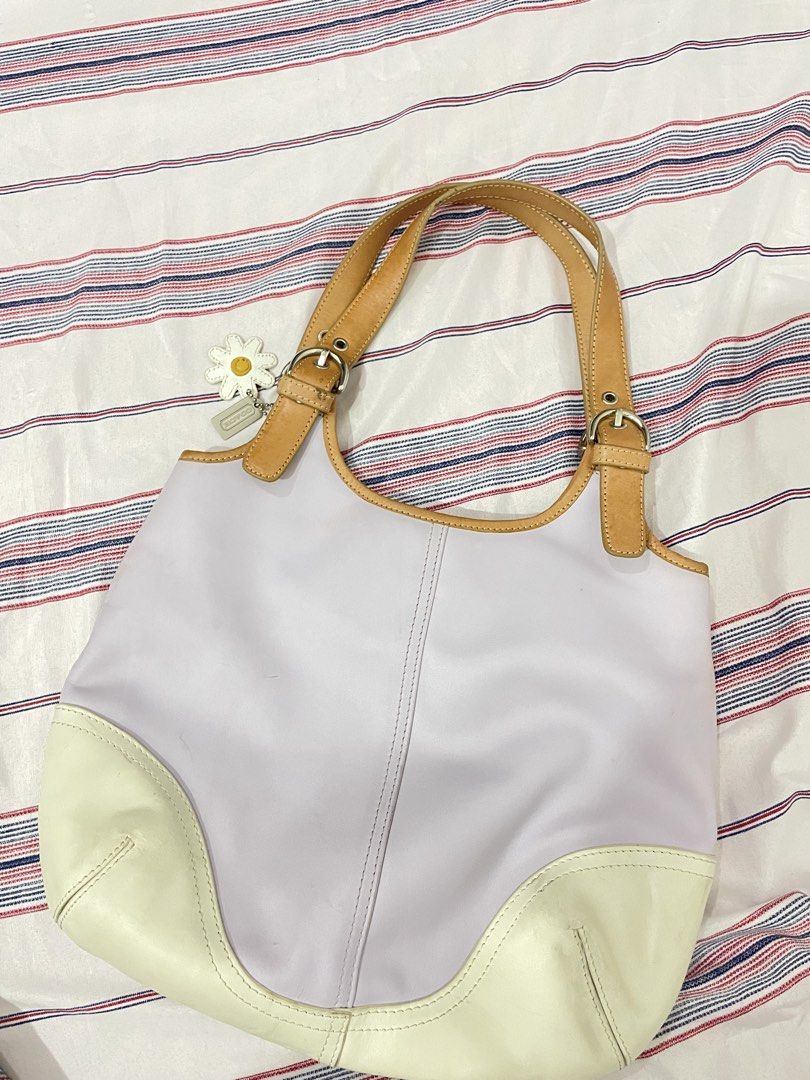 Coach Lavender & Cream Leather Shoulder Bag (Category: Luxury Bags & Wallets) located in Manila. Submitted by epicwhale-cd67 (Listing ID 1461427032, Image 2). Description: - Authentic Coach shoulder bag - Lovely lavender and cream color - Made from genuine leather - Interior zip pocket for essentials - Secure magnetic snap closure - Adorable daisy charm included - Perfect for daily use - Shows some signs of wear, but still in great usable conditi