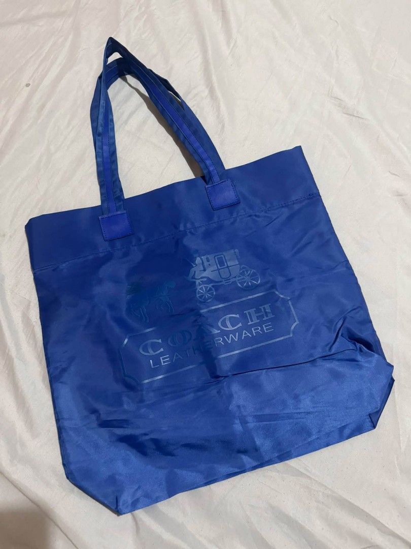 Coach Leatherware Blue Nylon Tote Bag (Category: Luxury Bags & Wallets) located in Manila. Submitted by shy177 (Listing ID 1461383695, Image 2). Description: - Blue Coach tote bag - Made of durable nylon - Features the iconic Coach Leatherware logo on the front - Includes an interior zippered pocket for secure storage - Sturdy handles for comfortable carrying - Ideal for everyday use and shopping trips.