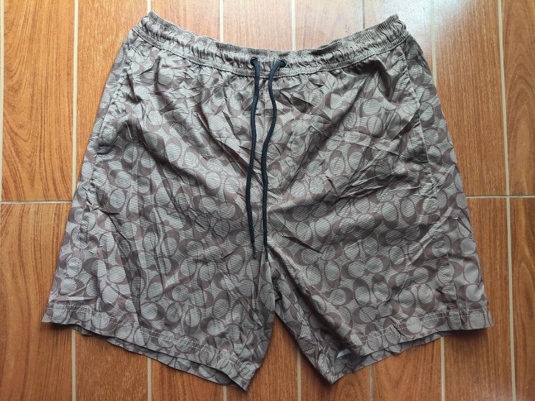 Coach Men's Patterned Swim Shorts (Category: Shorts) located in Caloocan City. Submitted by balizaclar77072 (Listing ID 1461426951, Image 1). Description: - Stylish Coach swim shorts with a cool all-over pattern. - Comfortable elastic waistband with adjustable drawstring. - Features a built-in mesh lining. - Ideal for beach days or poolside lounging. - Made in China. Please check photos for condition..