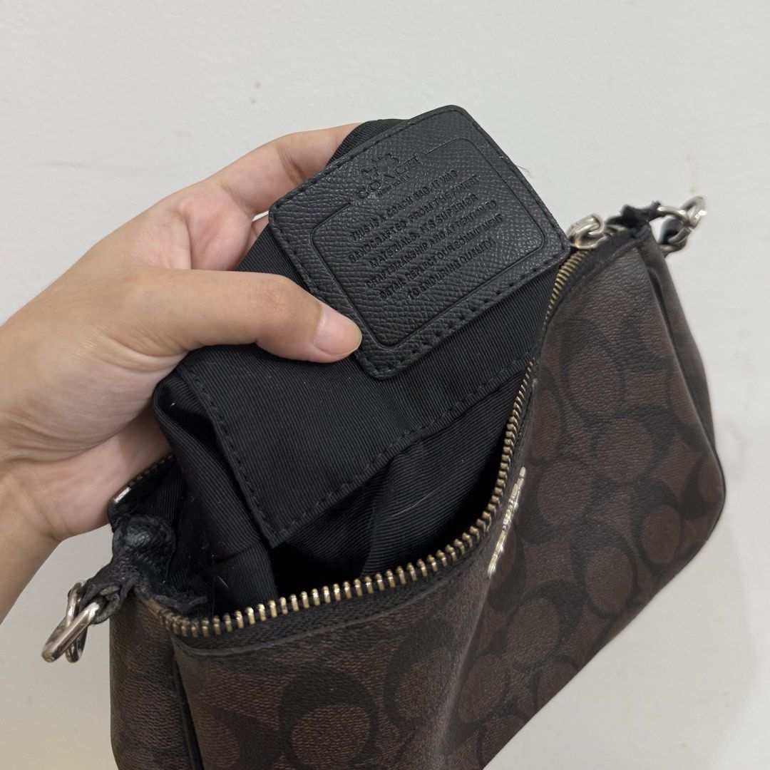 Coach Monogram Canvas Handbag (Category: Shoulder Bags) located in Baguio. Submitted by _jaiiii (Listing ID 1461512469, Image 2). Description: - Authentic Coach monogram canvas wristlet - Zipper closure - Small attached strap - Interior Coach branding tag - Minor signs of wear on strap and zipper edges - Ideal for carrying essentials.