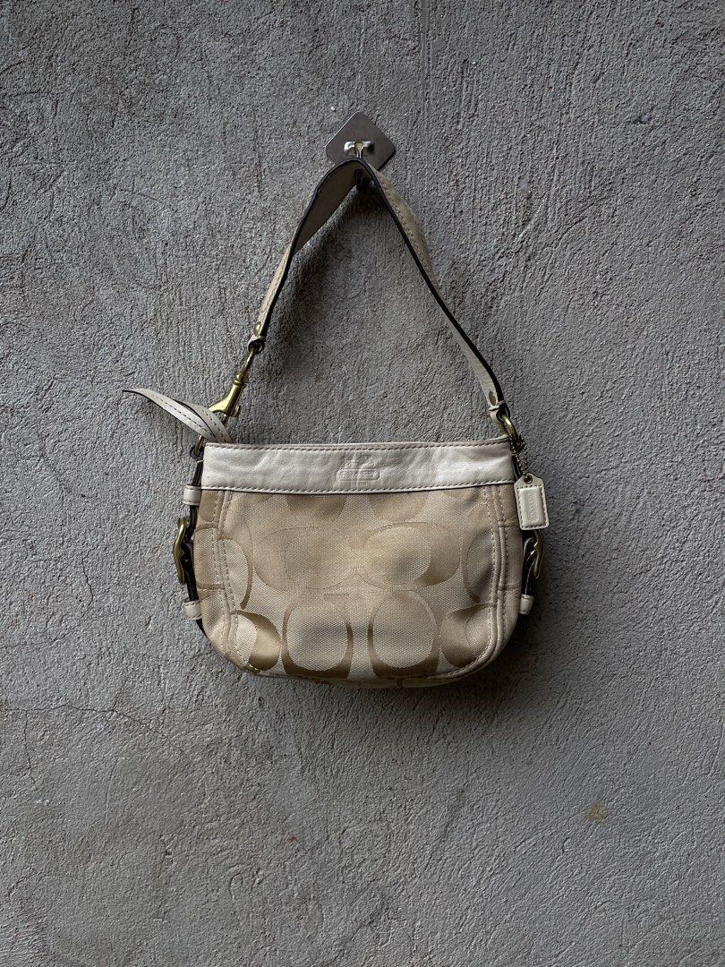 Coach Monogram Canvas Leather Trim Shoulder Bag (Category: Luxury Bags & Wallets) located in Guihulngan. Submitted by johnrealvi59756 (Listing ID 1461330548, Image 1). Description: - Classic Coach shoulder bag - Beige canvas with signature 'C' monogram - Cream leather trim and strap - Gold-tone hardware - Small size, perfect for essentials.