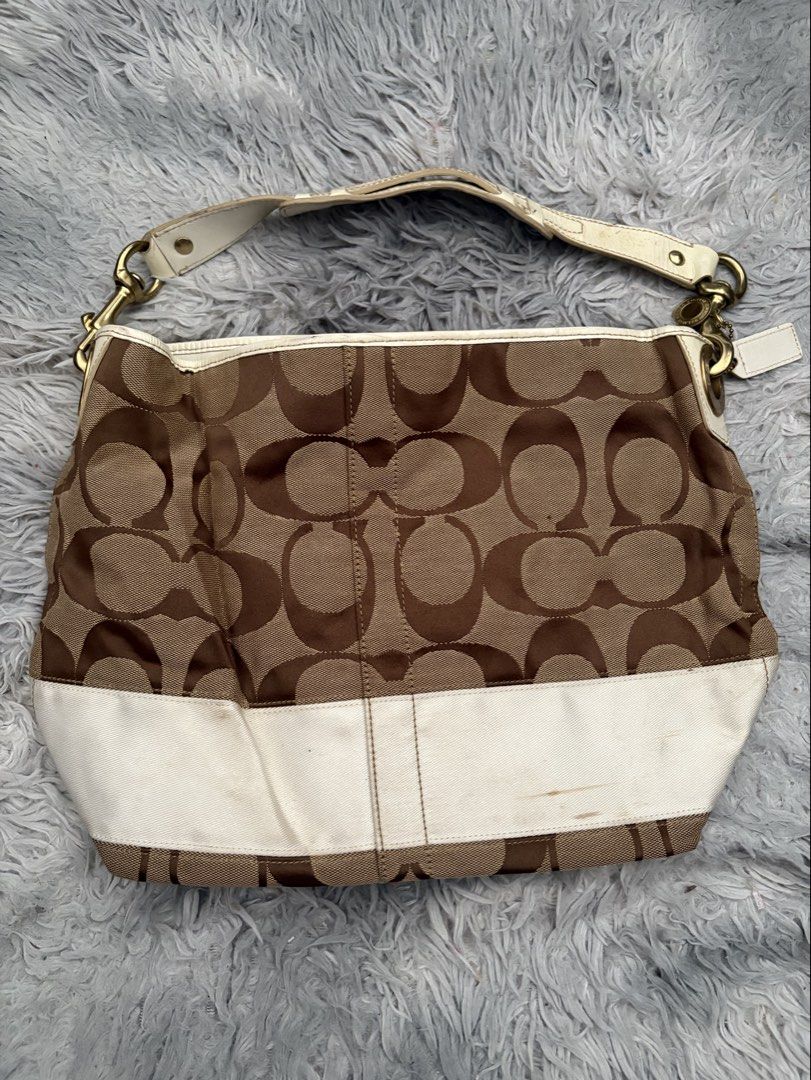 Coach Monogram Canvas Leather Shoulder Bag (Category: Luxury Bags & Wallets) located in San Pedro. Submitted by maria_xoxo (Listing ID 1461411918, Image 2). Description: - Authentic Coach monogram shoulder bag - Classic brown and white colorway - White leather strap and trim - Interior: 1 zippered pocket, 1 slip pocket - Gold hardware - Plenty of life left, great pre-loved condition.