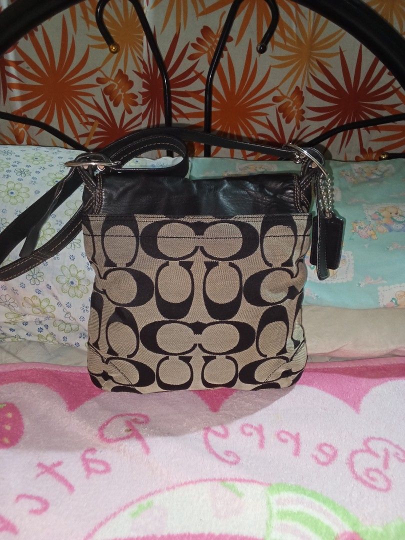 Coach Monogram Canvas Leather cross bodyBag (Category: Luxury Bags & Wallets) located in Manila. Submitted by aradoanita90032 (Listing ID 1461430301, Image 2). Description: - Classic Coach shoulder bag - Signature monogram canvas with black leather trim - Silver buckle detail on the front flap - Adjustable leather strap - Great everyday bag - Plenty of space inside.