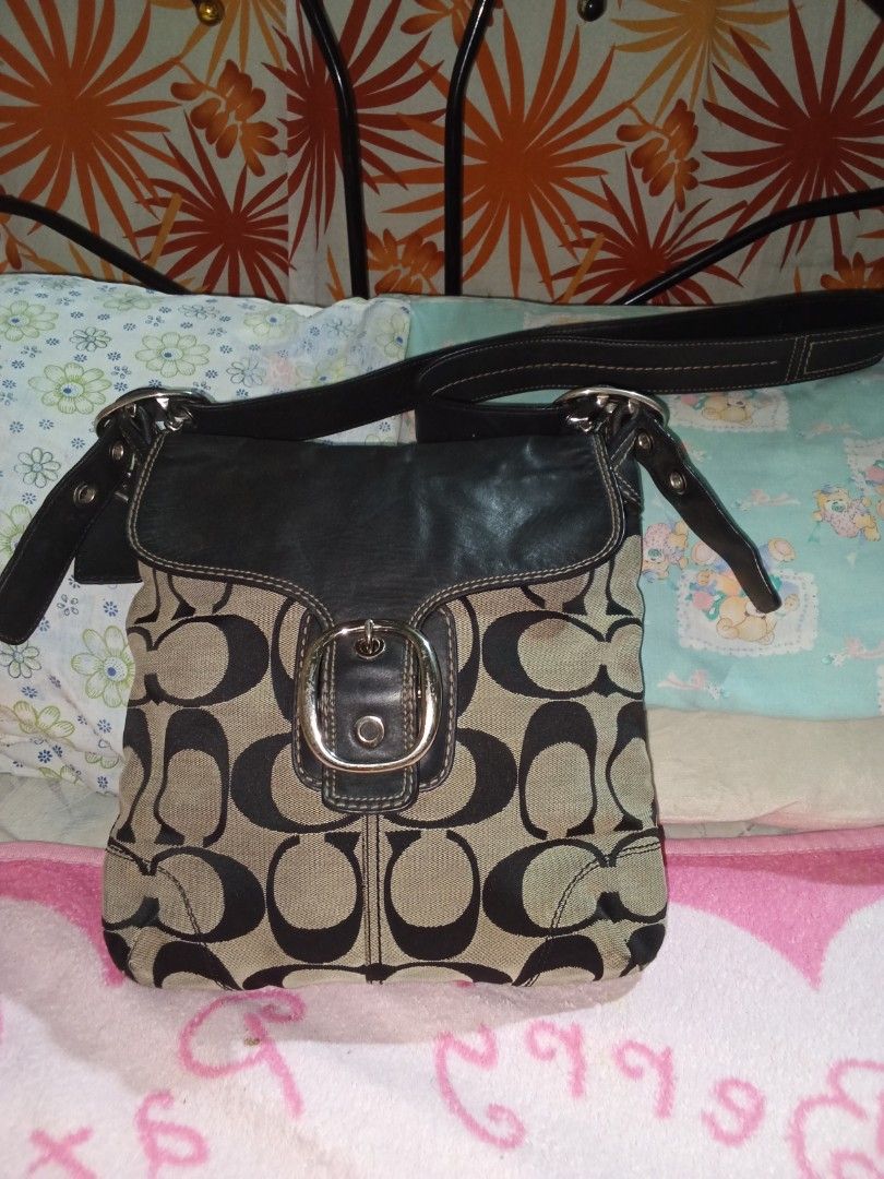 Coach Monogram Canvas Leather cross bodyBag (Category: Luxury Bags & Wallets) located in Manila. Submitted by aradoanita90032 (Listing ID 1461430301, Image 1). Description: - Classic Coach shoulder bag - Signature monogram canvas with black leather trim - Silver buckle detail on the front flap - Adjustable leather strap - Great everyday bag - Plenty of space inside.