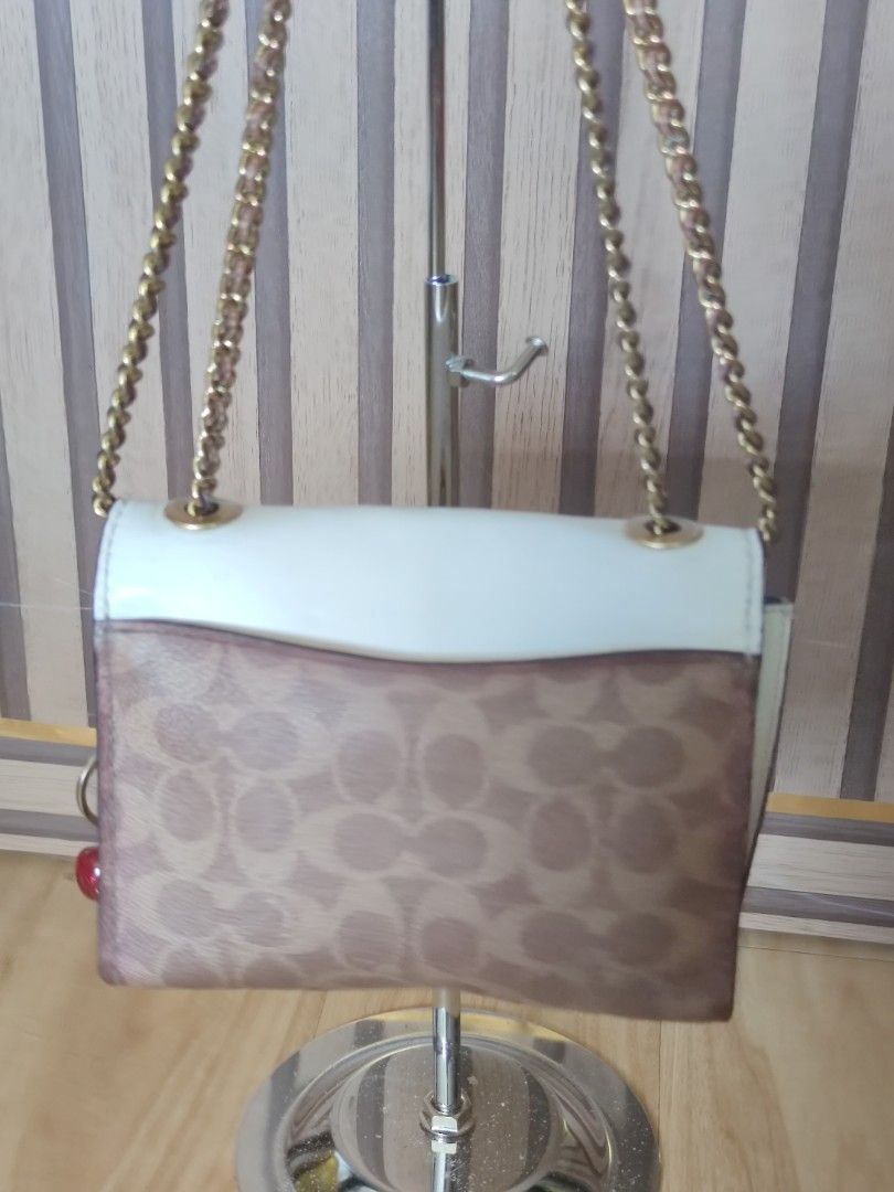 Coach Parker 18 Small, convertible bag (Category: Luxury Bags & Wallets) located in Dagupan City. Submitted by jhazrightshop (Listing ID 1461446049, Image 3). Description: - Coach crossbody bag - Signature print - White flap closure with gold flower detail - Adorable cherry charm included - Gold chain strap - Ideal for casual outings.