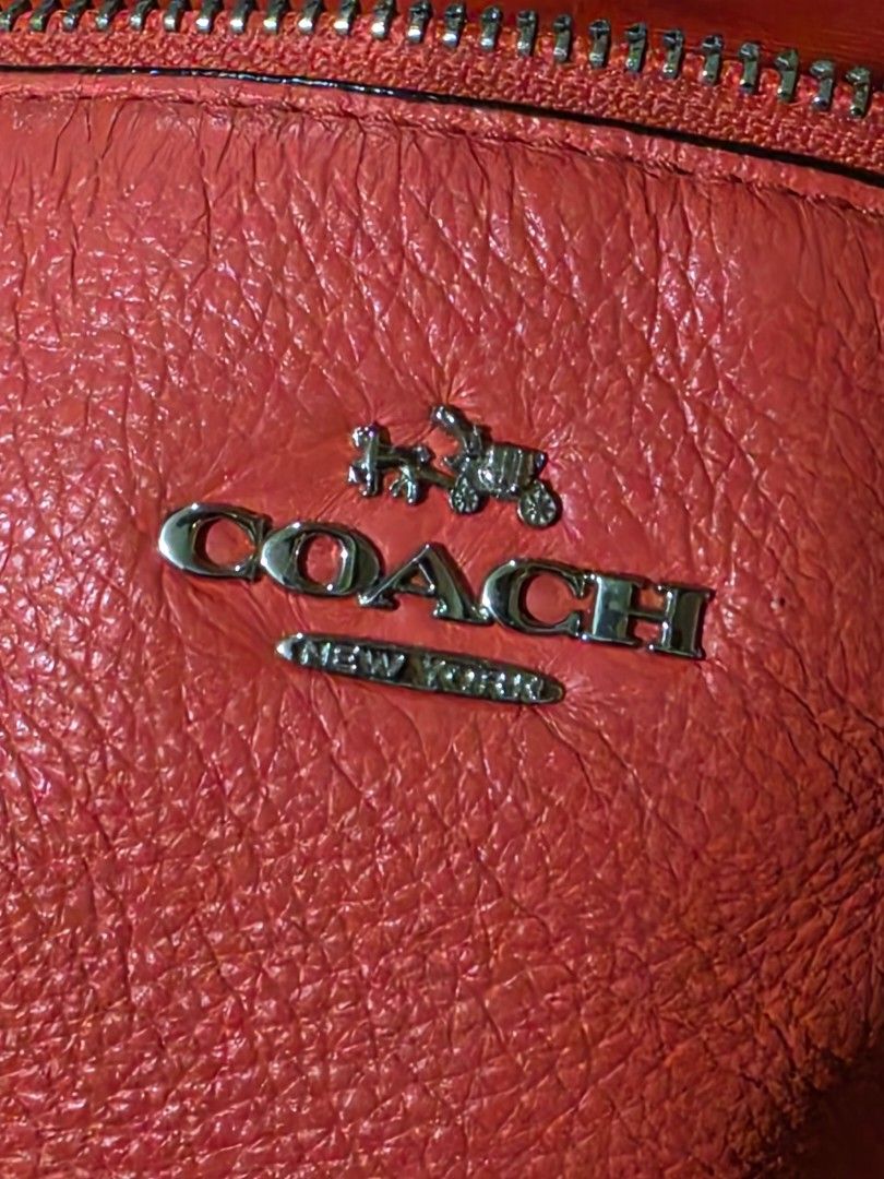 Coach Pebbled Leather Satchel Handbag (Category: Luxury Bags & Wallets) located in Cebu City. Submitted by mjcolinacebu20 (Listing ID 1461409773, Image 3). Description: - Orange pebbled leather Coach satchel - Silver hardware details - Top handles and detachable crossbody strap - Secure zipper closure - Interior: zippered pocket and slip pockets - Minor marks on interior lining ( kamo nlng limpyo sa inside as seen in the picture) - Ideal for ever