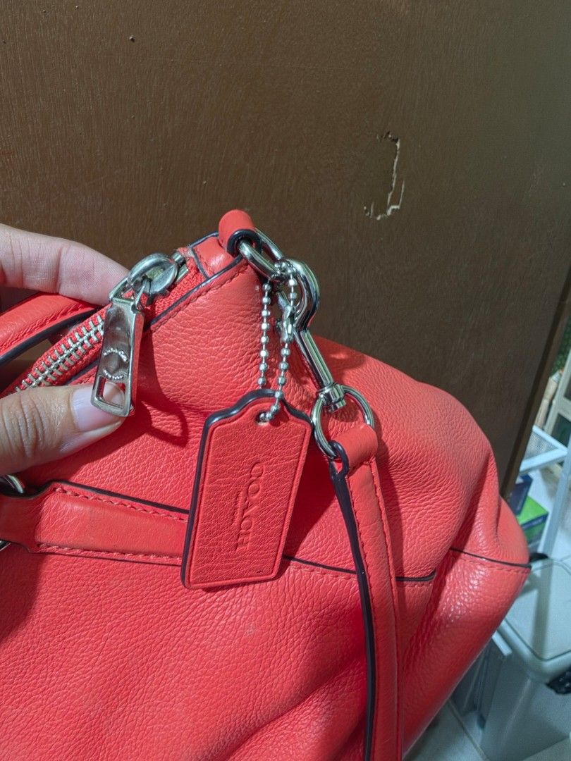 Coach Pebbled Leather Satchel Handbag (Category: Luxury Bags & Wallets) located in Cebu City. Submitted by mjcolinacebu20 (Listing ID 1461409773, Image 2). Description: - Orange pebbled leather Coach satchel - Silver hardware details - Top handles and detachable crossbody strap - Secure zipper closure - Interior: zippered pocket and slip pockets - Minor marks on interior lining ( kamo nlng limpyo sa inside as seen in the picture) - Ideal for ever