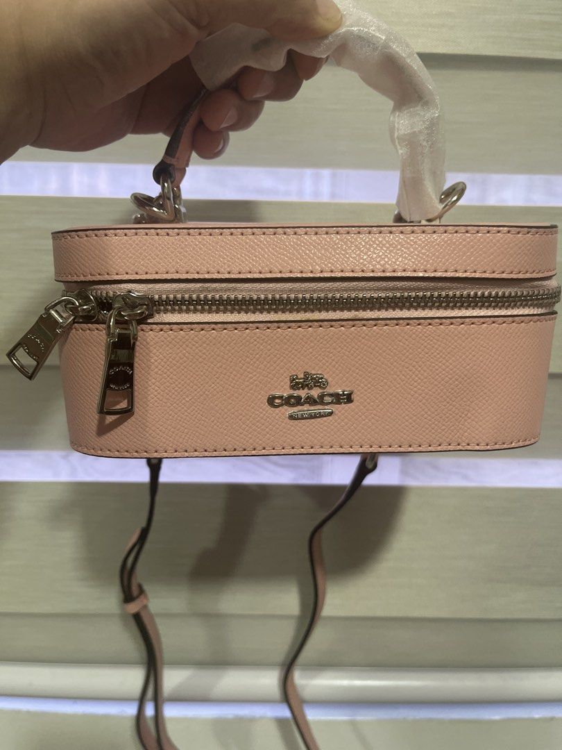 Coach Pink Leather Vanity Case Bag with Chain Strap (Category: Cross-body Bags) located in Pasig City. Submitted by melaiski28 (Listing ID 1461330964, Image 1). Description: - Cute pink Coach vanity case bag - Textured leather - Top handle and detachable chain strap - Spacious interior with zip closure - Ideal for makeup or small essentials - Silver hardware details - Approximately 7 inches long.