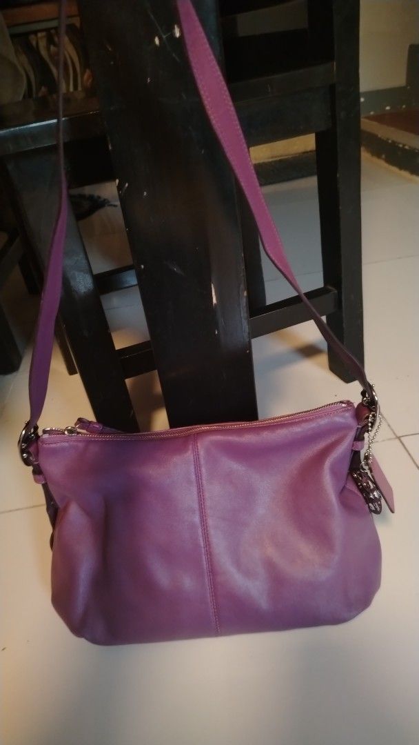 Coach Purple Leather Shoulder Bag (Category: Shoulder Bags) located in Manila. Submitted by wildwind_73f77a (Listing ID 1461509761, Image 3). Description: - Authentic purple Coach shoulder bag - Made of soft, supple leather - Stylish slouchy shape - Adjustable shoulder strap for comfort - Secure zipper closure - Comes with original Coach hangtag and circular metal charm - Ample interior space for your essentials - Ideal everyday bag for a touch o