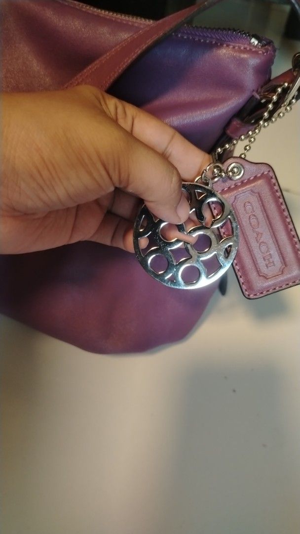 Coach Purple Leather Shoulder Bag (Category: Shoulder Bags) located in Manila. Submitted by wildwind_73f77a (Listing ID 1461509761, Image 2). Description: - Authentic purple Coach shoulder bag - Made of soft, supple leather - Stylish slouchy shape - Adjustable shoulder strap for comfort - Secure zipper closure - Comes with original Coach hangtag and circular metal charm - Ample interior space for your essentials - Ideal everyday bag for a touch o