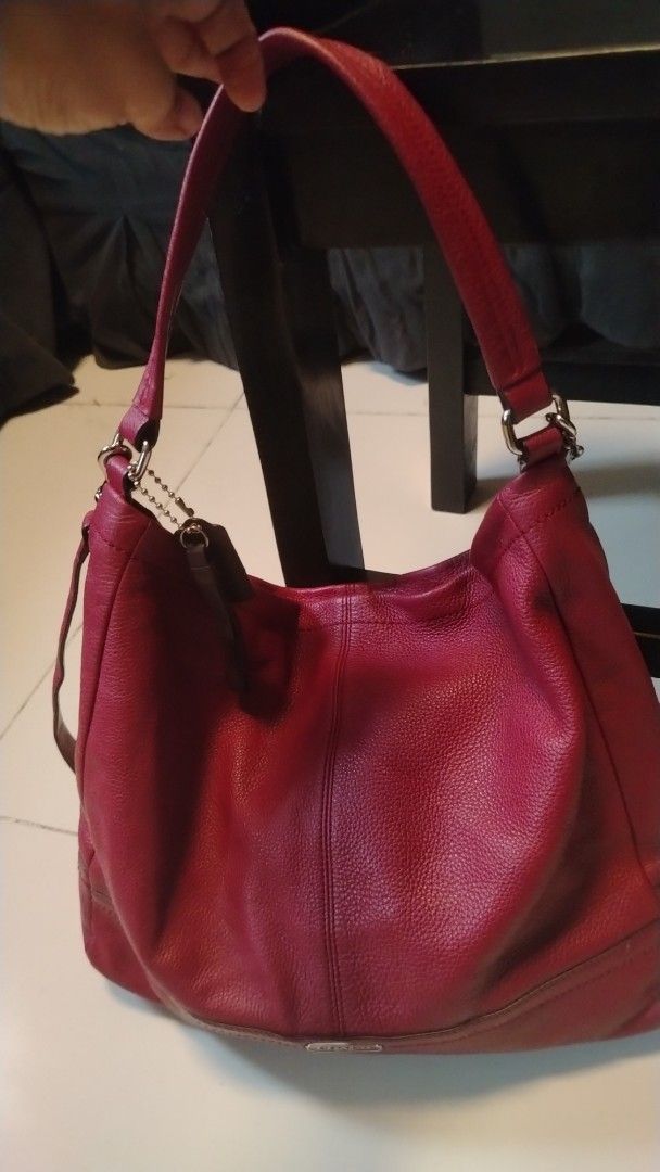 Coach Red Leather Hobo Shoulder Bag (Category: Shoulder Bags) located in Manila. Submitted by wildwind_73f77a (Listing ID 1461510702, Image 1). Description: - Genuine red pebbled leather Coach hobo bag - Elegant silver hardware details - Secure zip-top main compartment - Convenient interior slip pockets - Adjustable shoulder strap for comfort - Ideal everyday bag.