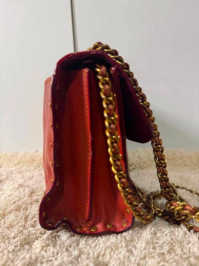 Coach Red Leather Studded Chain Shoulder Bag (Category: Luxury Bags & Wallets) located in Manila. Submitted by shy177 (Listing ID 1461390647, Image 2). Description: - Genuine red leather shoulder bag - Accented with stylish gold studs - Iconic Coach monogram print on the flap - Unique flower-shaped clasp closure - Elegant gold-toned chain strap - Luxurious burgundy interior lining - Serial number for authenticity.