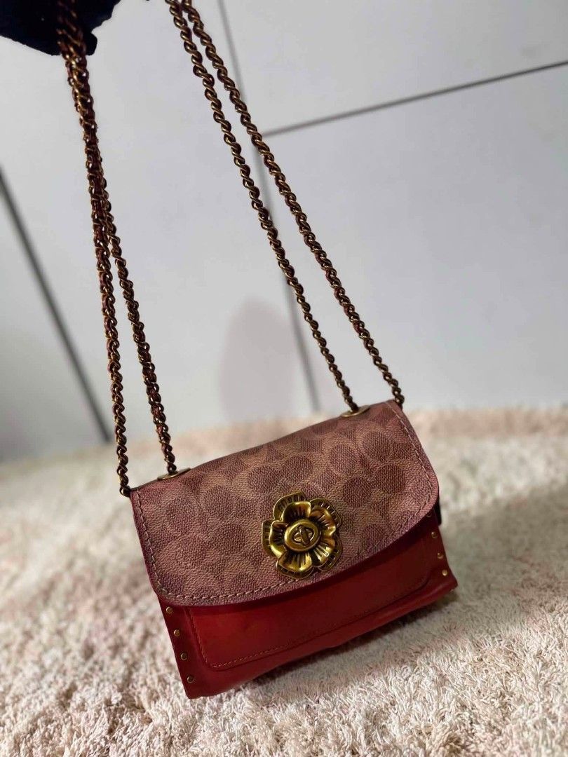 Coach Red Leather Studded Chain Shoulder Bag (Category: Luxury Bags & Wallets) located in Manila. Submitted by shy177 (Listing ID 1461390647, Image 3). Description: - Genuine red leather shoulder bag - Accented with stylish gold studs - Iconic Coach monogram print on the flap - Unique flower-shaped clasp closure - Elegant gold-toned chain strap - Luxurious burgundy interior lining - Serial number for authenticity.