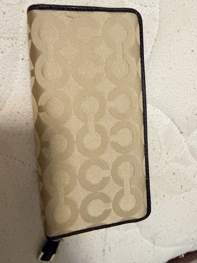 Coach Signature C Monogram Zip Around Wallet (Category: Luxury Bags & Wallets) located in Valenzuela. Submitted by itsmelissamd (Listing ID 1461358396, Image 2). Description: - Authentic Coach wallet - Signature C monogram pattern - Brown leather trim - Gold hardware - Secure zip-around closure - Multiple interior compartments for cards and cash - Zippered coin pocket - Ideal for everyday use.
