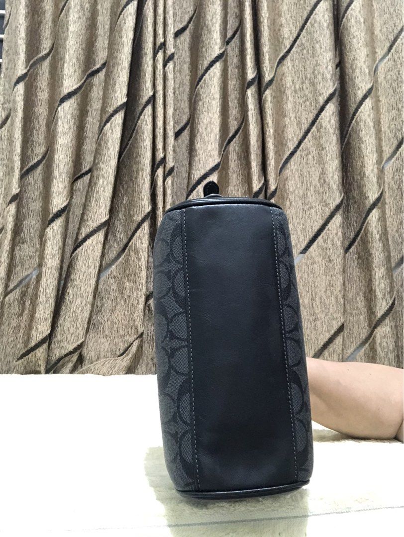Coach Signature Monogram Barrel Bag (Category: Luxury Bags & Wallets) located in Rizal. Submitted by elviedc2420209 (Listing ID 1461508016, Image 3). Description: - Authentic Coach barrel bag in black signature print. - Features elegant leather trim and strap. - Secure zipper closure. - Includes a detachable wrist strap for versatility. - Can be worn as a crossbody or shoulder bag. - Ample interior space for your daily essentials. - Perfect for e