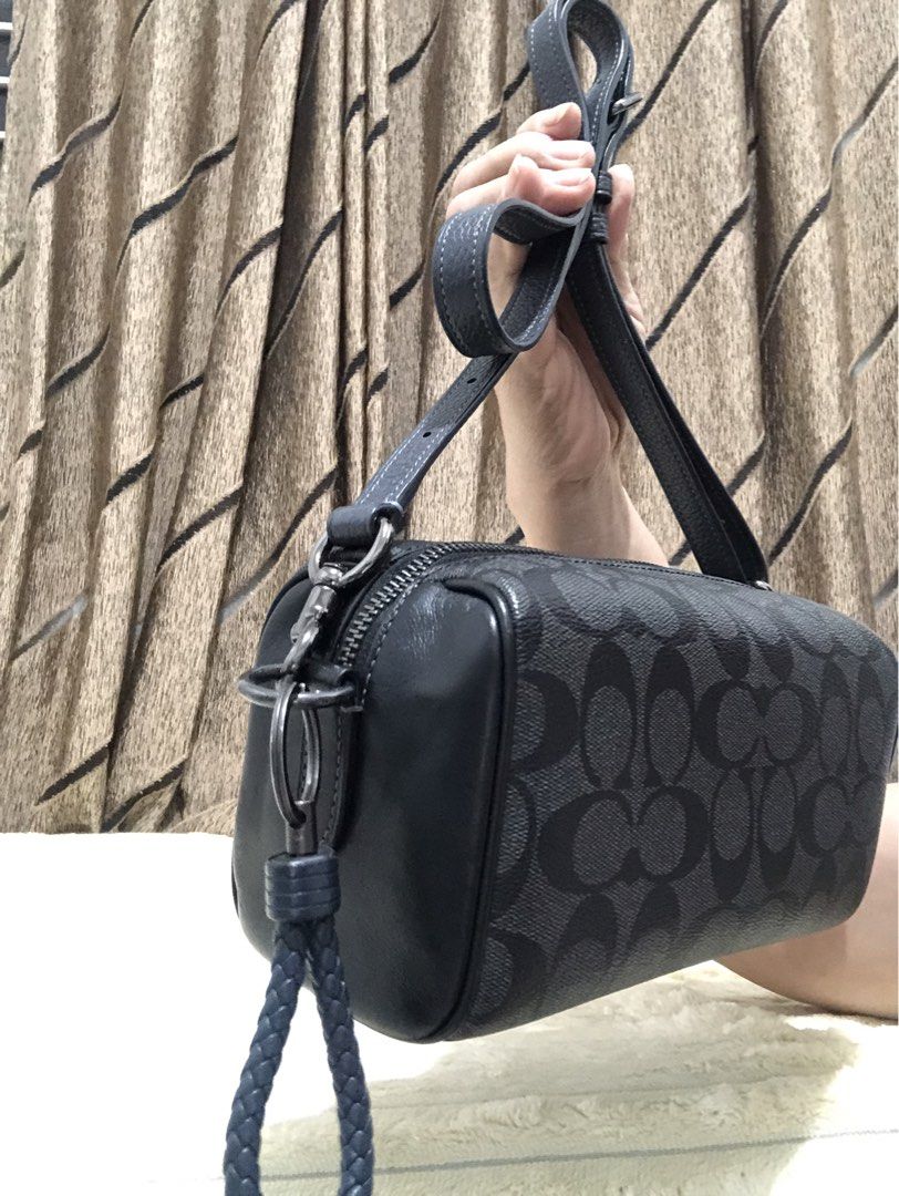 Coach Signature Monogram Barrel Bag (Category: Luxury Bags & Wallets) located in Rizal. Submitted by elviedc2420209 (Listing ID 1461508016, Image 2). Description: - Authentic Coach barrel bag in black signature print. - Features elegant leather trim and strap. - Secure zipper closure. - Includes a detachable wrist strap for versatility. - Can be worn as a crossbody or shoulder bag. - Ample interior space for your daily essentials. - Perfect for e