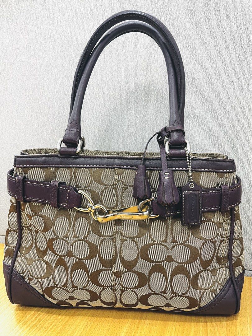 Coach Signature Monogram Canvas & Leather Shoulder Bag (Category: Luxury Bags & Wallets) located in Pasig City. Submitted by zen_it_all (Listing ID 1461470744, Image 2). Description: - Authentic Coach monogram canvas and leather handbag - Chic purple leather trim and handles - Elegant Silver-tone hardware -Jacket type zipper - Includes signature Coach hangtag and tassel -signs of usage (pre-loved) - Ample interior space for your essentials - Idea