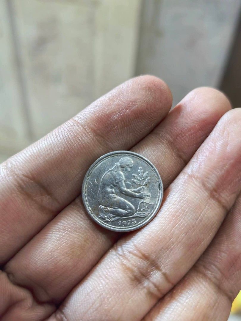 Coin - 1973 West German 50 Pfennig (Category: Currency) located in Cebu City. Submitted by dudes_villanueva (Listing ID 1461326749, Image 1). Description: Coin - 1973 West German 50 Pfennig piece featuring a woman planting an oak tree. 📌 Country: West Germany (Federal Republic of Germany) 📌 Denomination: 50 Pfennig (0.50 Deutsche Mark) 📌 Year Visible: 1973 📌 Composition: Copper-nickel 📌 Diameter: 20 mm 📌 Weight: 3.5 grams 📌 Design: A kneel