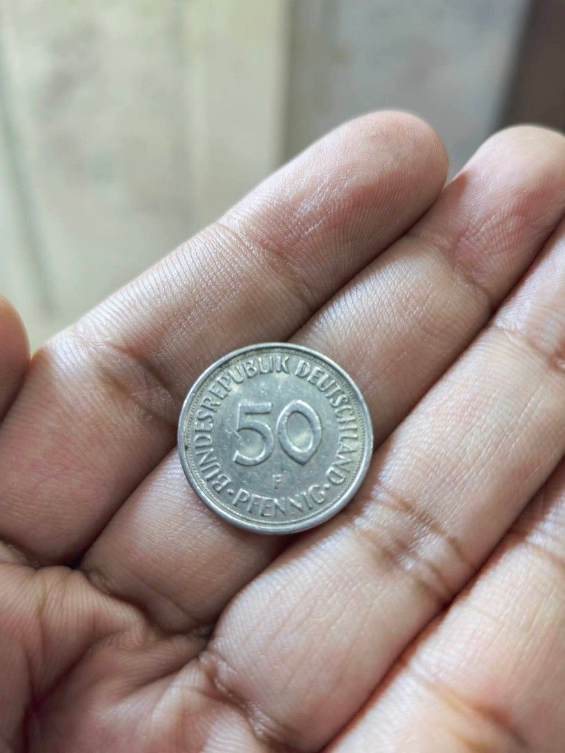 Coin - 1973 West German 50 Pfennig (Category: Currency) located in Cebu City. Submitted by dudes_villanueva (Listing ID 1461326749, Image 2). Description: Coin - 1973 West German 50 Pfennig piece featuring a woman planting an oak tree. 📌 Country: West Germany (Federal Republic of Germany) 📌 Denomination: 50 Pfennig (0.50 Deutsche Mark) 📌 Year Visible: 1973 📌 Composition: Copper-nickel 📌 Diameter: 20 mm 📌 Weight: 3.5 grams 📌 Design: A kneel
