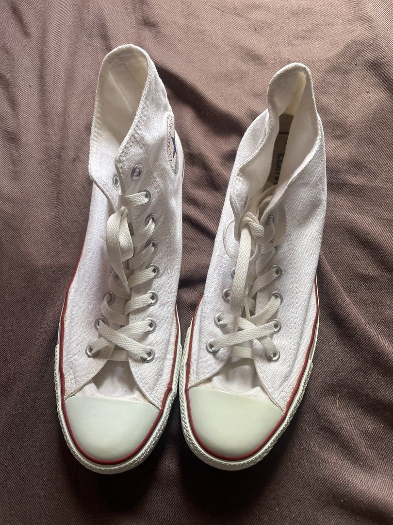Converse Chuck Taylor All Star High Top White Canvas (Category: Sneakers) located in Manila. Submitted by silentlion.f6b795 (Listing ID 1461368301, Image 3). Description: - Classic white Converse high tops - Durable canvas material - Red stripe detail on the sole - Secure lace-up closure - Iconic Chuck Taylor All Star logo on the side - Versatile for everyday wear - A wardrobe essential.