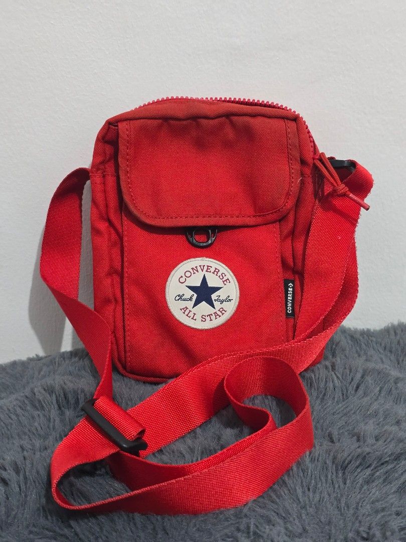 Converse Red Crossbody Bag (Category: Cross-body Bags) located in Manila. Submitted by trialfindsmanila (Listing ID 1461500172, Image 1). Description: This is authentic 💯 from US In good condition 💯 - Stylish red Converse crossbody bag - Main zippered compartment for secure storage - Front pocket with snap closure for quick access - Small zippered pocket on the back for extra organization - Adjustable strap for a comfortable fit - Ideal for car