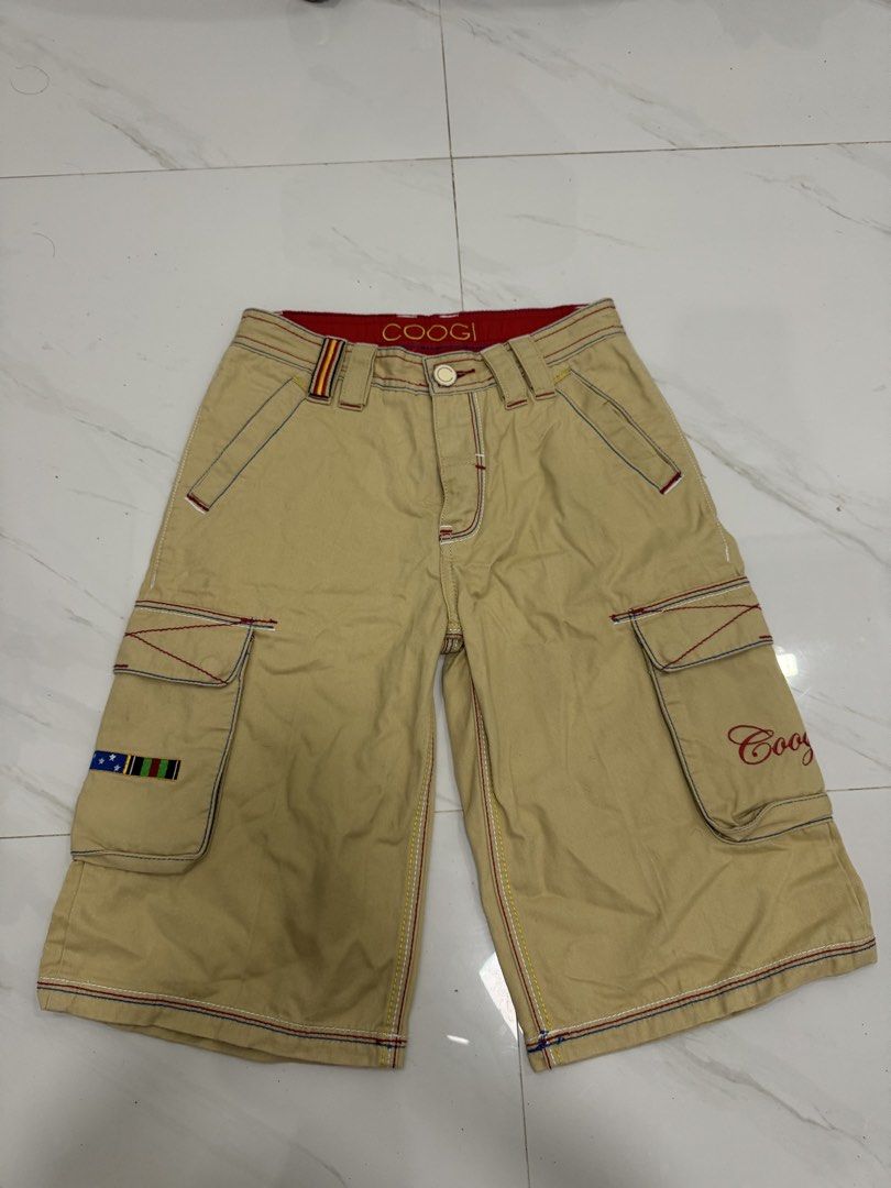 Coogi Cargo Shorts - Tan with Embroidered Compass & Flags (Category: Shorts) located in Manila. Submitted by yelutot (Listing ID 1461546739, Image 2). Description: - Tan Coogi cargo shorts - Embroidered compass graphic on back pocket - Union Jack flag detail on side pocket - Multiple pockets for ample storage - Ideal for casual wear.