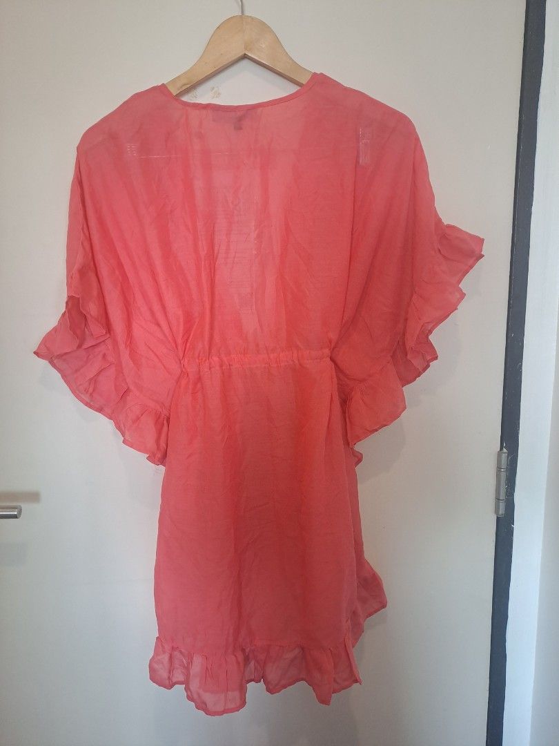 Coral pink ruffled Cover up (Category: Others Tops) located in Manila. Submitted by joanbalde39643 (Listing ID 1461402797, Image 3). Description: This piece is a coral pink ruffled kaftan swim cover-up dress, a light and airy vacation staple designed to be layered over swimwear..