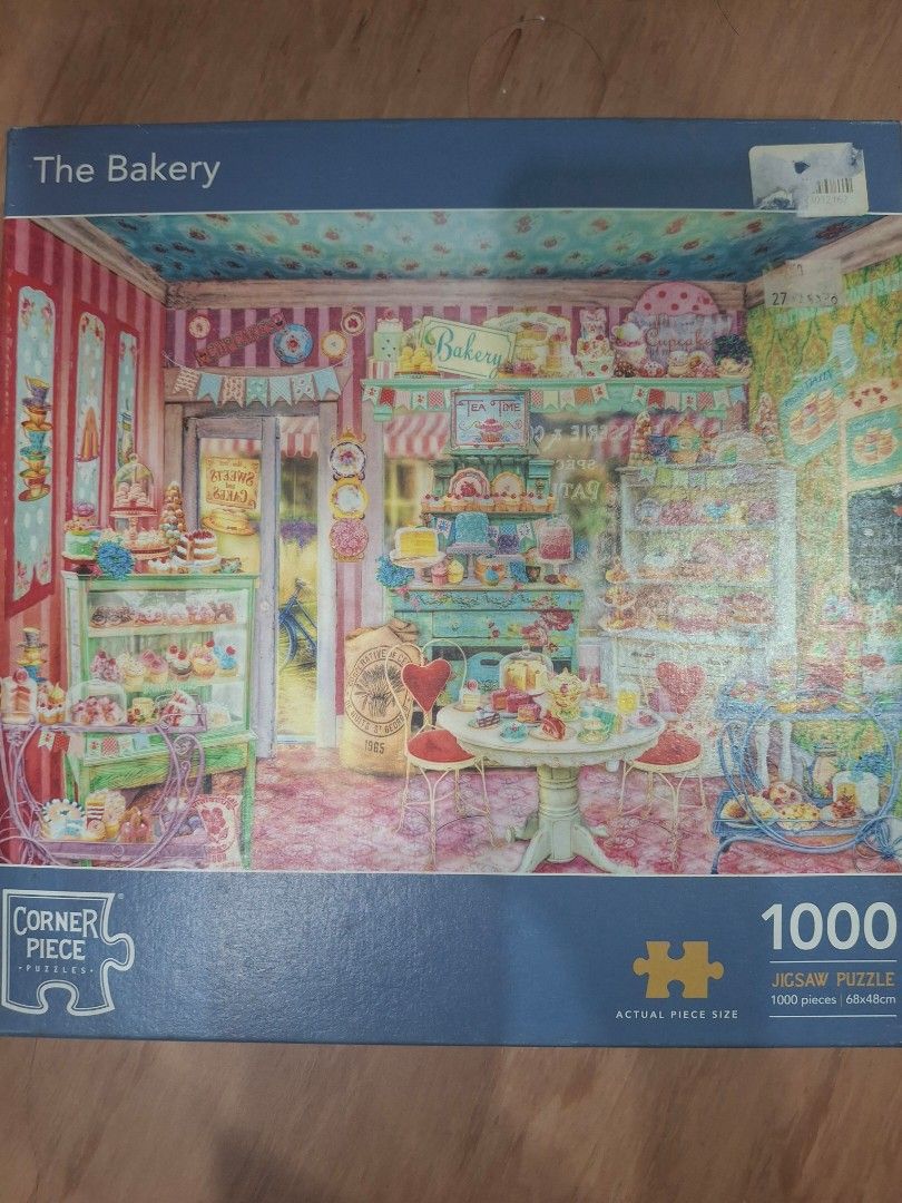 Corner Piece 1000 Piece Jigsaw Puzzle - The Bakery (Category: Board Games & Puzzles) located in Manila. Submitted by mamanilala (Listing ID 1461440748, Image 1). Description: pre-loved! missing 1pc 😔 will still be a fun build! very challenging build 😅 shipping from QC, buyer to shoulder shipping fee - Brand: Corner Piece - Puzzle Name: The Bakery - Piece Count: 1000 pieces - Image Description: Cute, colorful bakery interior filled with sweets -