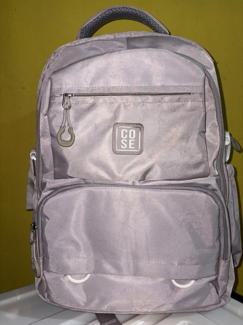 COSE Grey Backpack (Category: Backpacks) located in Manila. Submitted by cleverwater2528 (Listing ID 1461479935, Image 1). Description: - Brand: COSE - Color: Grey - Features: Multiple zippered compartments, spacious main compartment, front pocket for small items - Comfort: Padded straps - Ideal for: School, everyday use PRICE IS STILL NEGOTIABLE.