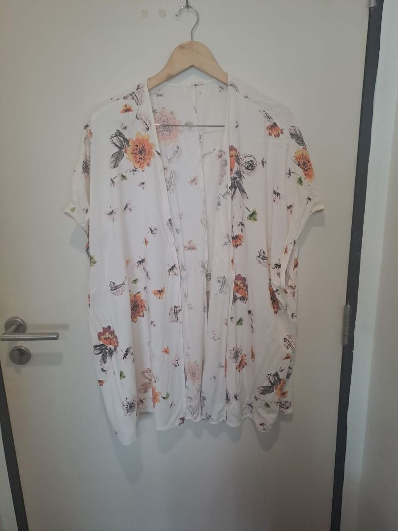 COTON COVER UP (Category: Others Tops) located in Mandaluyong City. Submitted by epicowl-c93c (Listing ID 1461430851, Image 1). Description: This is a boho-style floral print kimono cardigan, featuring a loose, lightweight silhouette with an open front and drop-shoulder short sleeves. The ivory fabric is decorated with a vibrant, scattered wildflower print in shades of orange, yellow, and black..