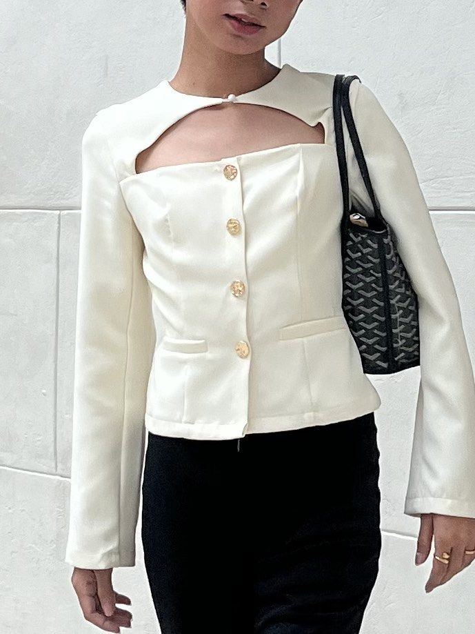 Cream Cut-out Blazer with Gold Buttons (Category: Coats, Jackets and Outerwear) located in Malolos. Submitted by vanderwoodsen_ (Listing ID 1461473373, Image 1). Description: - Chic cream colored blazer - Unique cut-out detail at the chest - Features three gold buttons down the front - Two faux pockets for a sleek look - Long sleeves - Versatile for dressing up skirts or trousers.