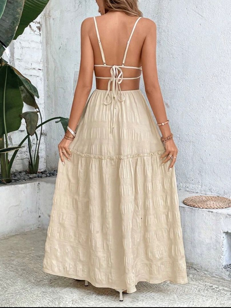 Cream Textured Tie-Back Maxi Dress (Category: Dresses) located in Manila. Submitted by vybeandstyleco (Listing ID 1461521705, Image 3). Description: - Cream colored maxi dress - Textured fabric - Open back with tie-back detail - Tiered skirt with ruffled hem - Spaghetti straps - Ideal for beach vacations or summer outings.