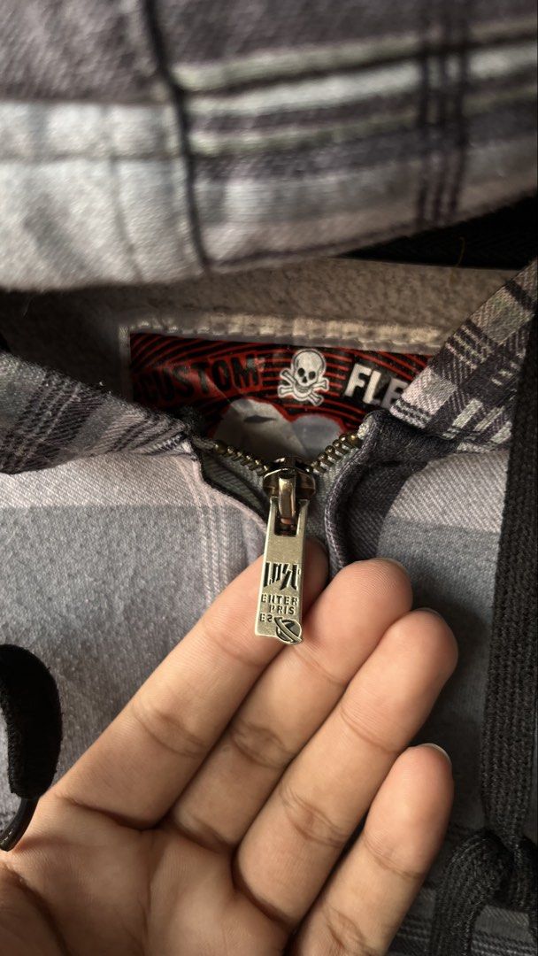 Vintage lost y2k Plaid Zip-Up Hoodie (Category: Coats, Jackets and Outerwear) located in Cabuyao City. Submitted by bulandos (Listing ID 1461431092, Image 2). Description: - Grey and white plaid zip-up hoodie - Black cuffs and hem - Skull and crossbones logo on the tag - Custom fit zipper pull - Front pocket - Ideal for casual wear.