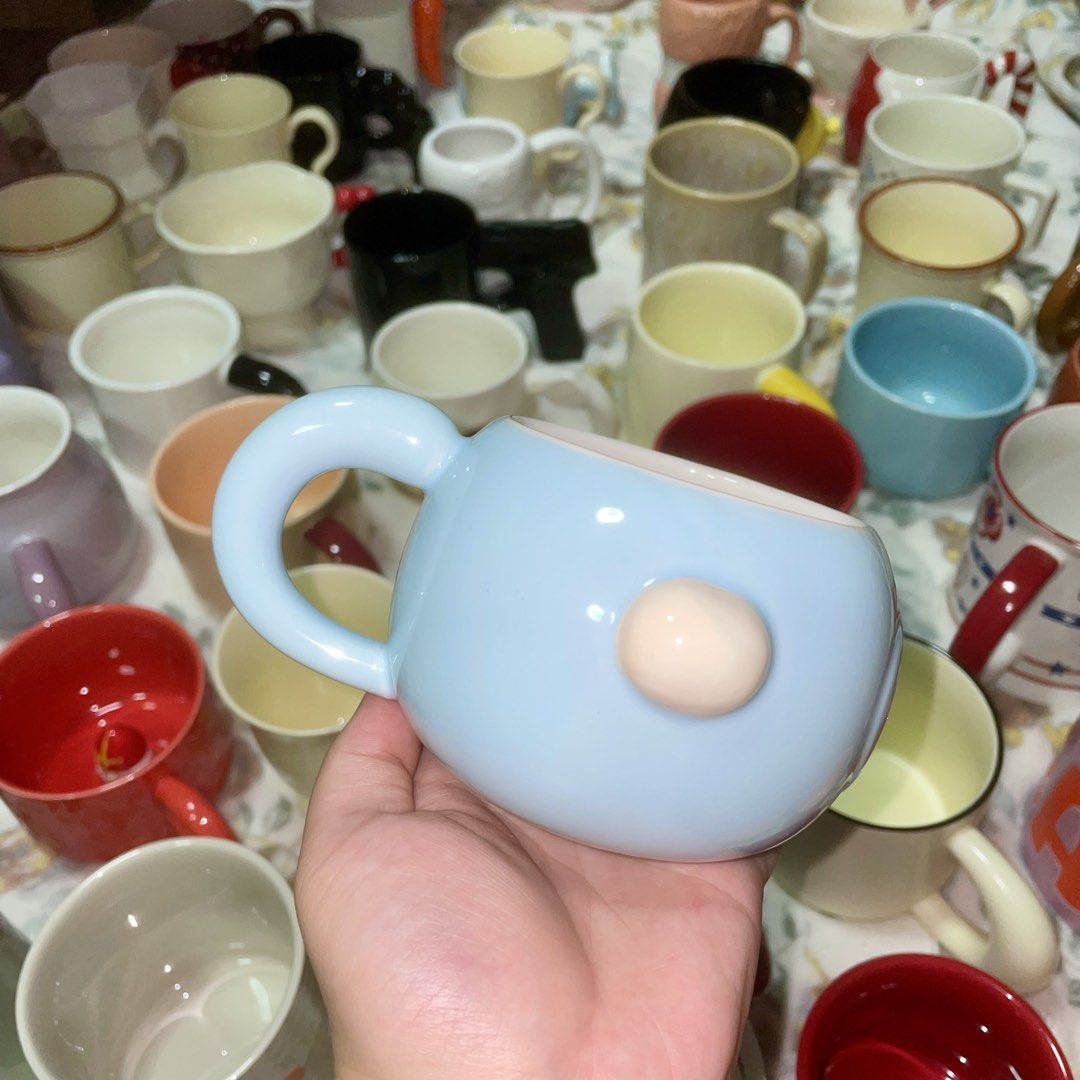 Cute Blue Chick Ceramic Mug with Handle (Category: Coffee & Tea Tableware) located in Valenzuela. Submitted by baekhyunie_pau (Listing ID 1461559616, Image 2). Description: Cute blue ceramic mug with chick design. Yellow star accent. Light pinkish-beige handle. Perfect for coffee or tea..