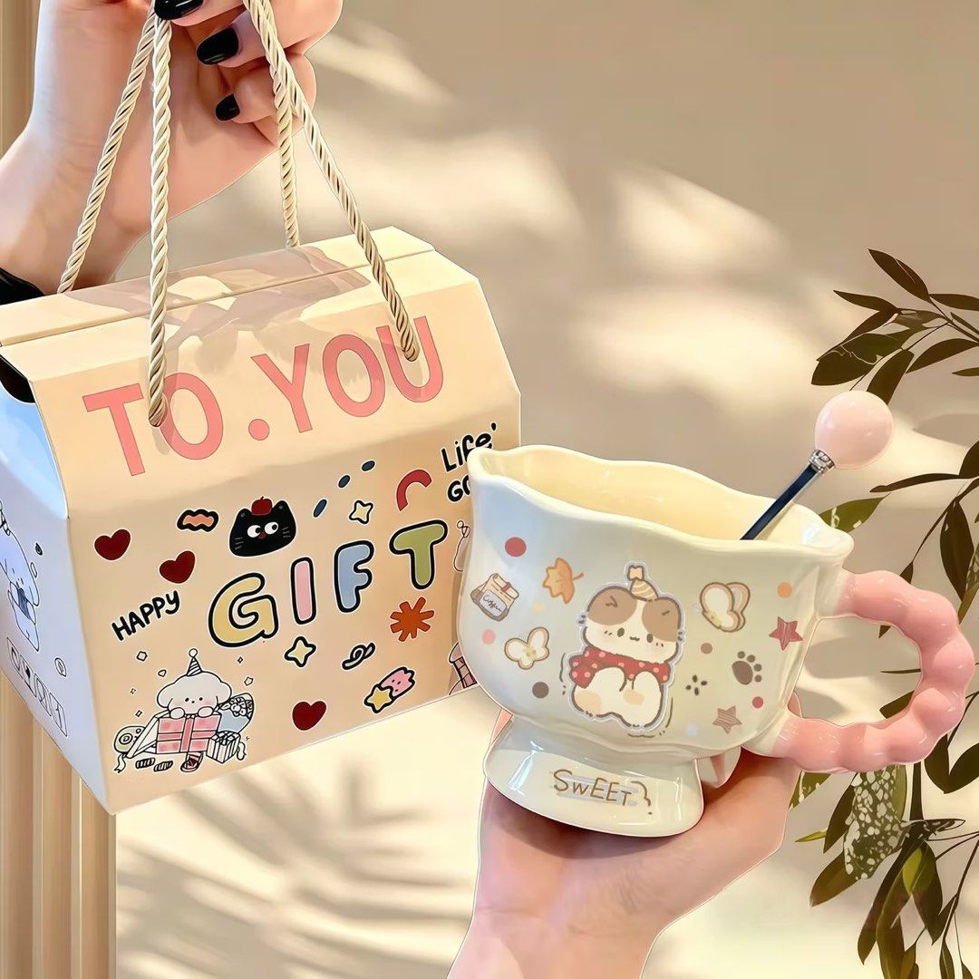 Cute Dog Mug with Gift Box and Spoon (Category: Coffee & Tea Tableware) located in Manila. Submitted by imnoturgirl (Listing ID 1461414547, Image 1). Description: - Adorable mug set featuring a cute dog design. - Unique pink wavy handle for a stylish touch. - Includes a matching spoon with a pink ball accent. - Presented in a charming 'To. You' gift box. - Perfect for enjoying coffee or tea. - Makes a wonderful gift for any occasion..