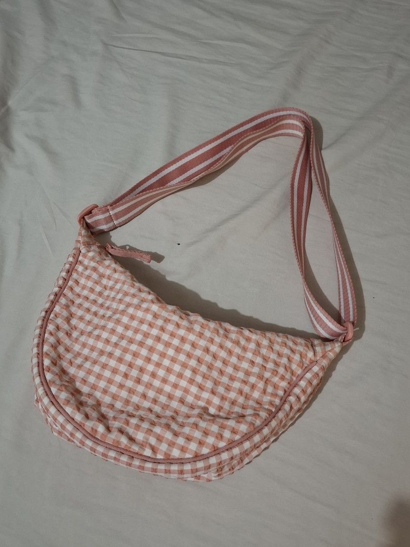Cute Gingham Shoulder Bag (Category: Shoulder Bags) located in Taguig. Submitted by plnmrtz (Listing ID 1461523190, Image 1). Description: - Adorable pink and white gingham pattern - Stylish curved shoulder bag design - Comfortable fabric strap - Interior pockets for easy organization - Secure zipper closure - Ideal for everyday wear - Used only once - RFS: Decluttering .