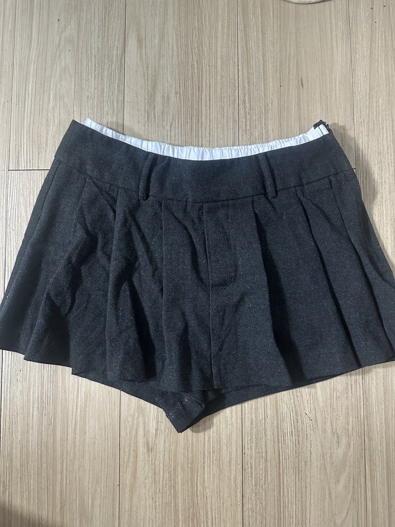 Dark Grey Pleated Skirt Shorts (Category: Skirts) located in Bacolod City. Submitted by kristellelopez (Listing ID 1461355488, Image 1). Description: - Dark grey skirt shorts with pleats - Elastic waistband with buckle detail - School uniform inspired style - Versatile for casual wear or costumes - Comfortable and stylish design.