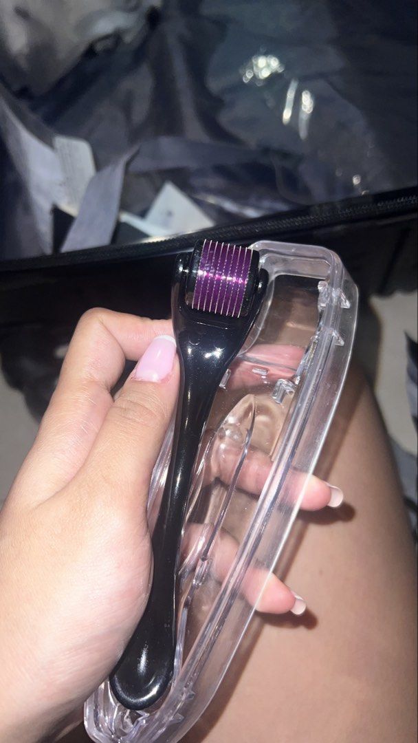 Derma Roller with Protective Case (Category: Face Care) located in Manila. Submitted by dianavictoriano (Listing ID 1461549466, Image 2). Description: - Black derma roller with a purple roller head - Comes with a clear protective case .