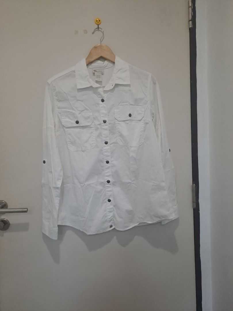 Dickies white linen cotton (Category: Longsleeves) located in Mandaluyong City. Submitted by epicowl-c93c (Listing ID 1461350245, Image 1). Description: The image shows a white Dickies utility work shirt designed for women. It features a classic collared neckline, a full button-down front with contrasting dark buttons, and two symmetrical chest patch pockets with buttoned flaps.The inner collar tag includes the brand logo and reads "Crafted for W