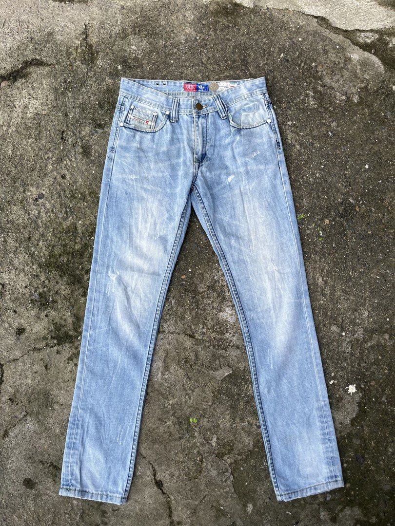 DIESEL X ADIDAS (Category: Jeans) located in Gapan. Submitted by jamminandcrackin (Listing ID 1461428716, Image 1). Description: - Brand: Diesel - Style: Light wash denim jeans - Fit: Straight leg - Details: Distressed areas and fading - Features: Classic Diesel logo on coin pocket and back waistband - Special: Inner lining with Adidas collaboration print - Occasion: Great for everyday wear.