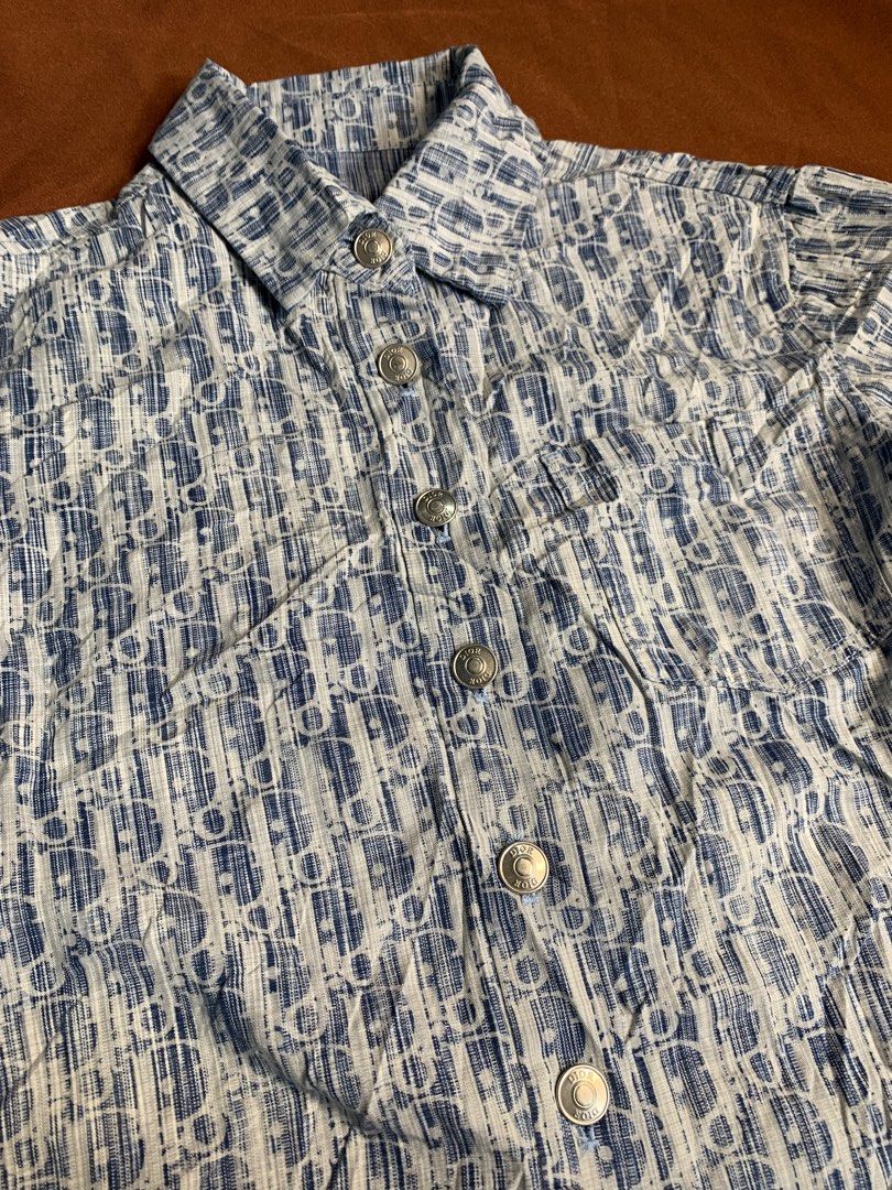 Dior Monogram Short Sleeve Button Up Shirt (Category: Shirts) located in Davao. Submitted by cheineebau09680 (Listing ID 1461475982, Image 2). Description: - Classic Dior monogram shirt - Iconic blue and white pattern - Short sleeves - Button-up front - Lightweight fabric, ideal for warm weather - Stylish addition to your wardrobe - Please check label for sizing.