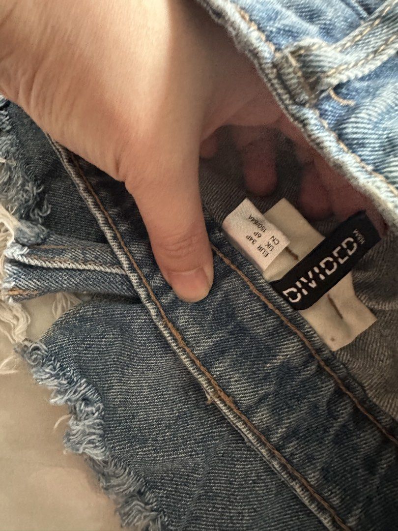 Divided by H&M Blue Denim Mini Skirt (Category: Skirts) located in Caloocan City. Submitted by brandeditemsph (Listing ID 1461422553, Image 3). Description: - Divided by H&M blue denim mini skirt - Frayed hem detail for a trendy look - Classic five-pocket styling - Secure button and zip closure - Versatile for casual wear, easily pairs with any top.