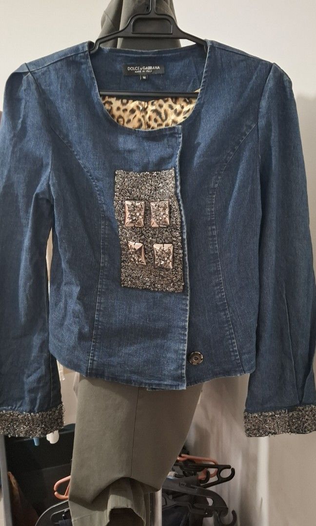 Dolce & Gabbana Fitted Denim Jacket with Beadwork (Category: Coats, Jackets and Outerwear) located in Bulacan. Submitted by ditchandswitch (Listing ID 1459674063, Image 3). Description: - Fitted Dolce & Gabbana denim blouson jacket - Intricate beadwork on the front and cuffs - Four ornate square buckles on the front - Luxurious leopard-print silk blend lining - A striking statement piece for any wardrobe.