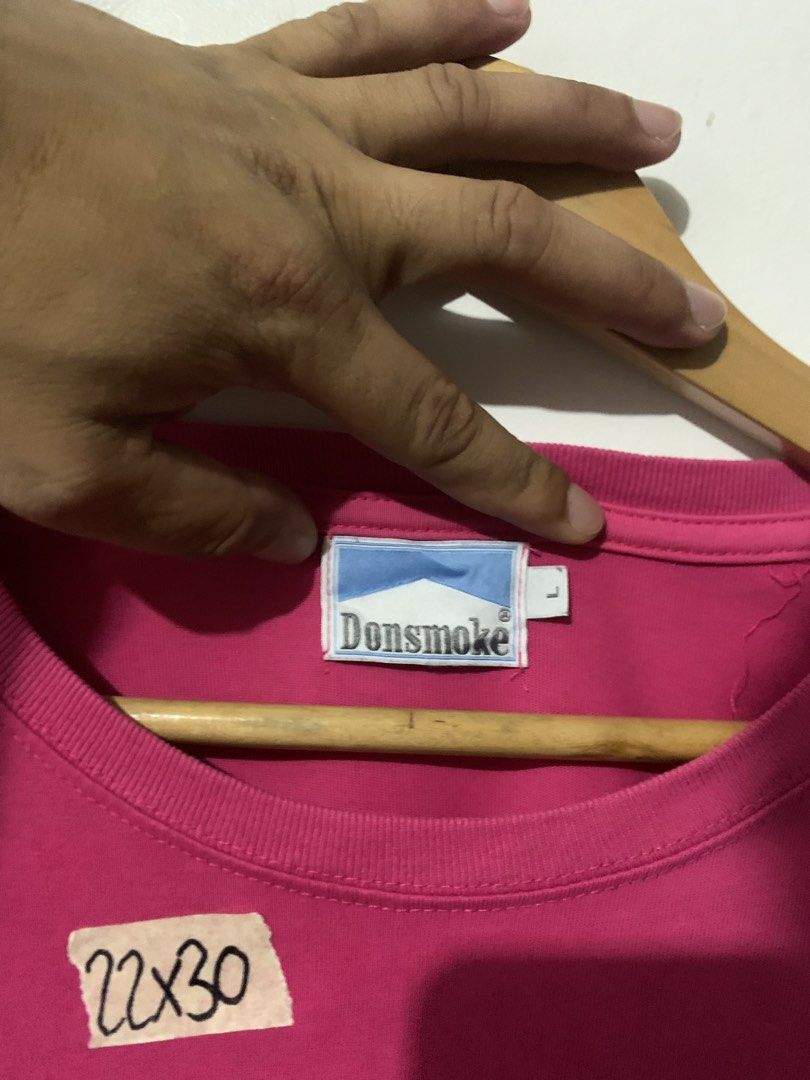 Donsmoke "I DON'T SMOKE" Graphic Tee (Category: Tshirts & Polo Shirts ) located in Manila. Submitted by tanjames.14 (Listing ID 1461445575, Image 3). Description: - Pink graphic tee from Donsmoke - Features bold "I DON'T SMOKE" slogan - Made from 100% cotton - Tagged size L - Care instructions available on label - Perfect statement piece.