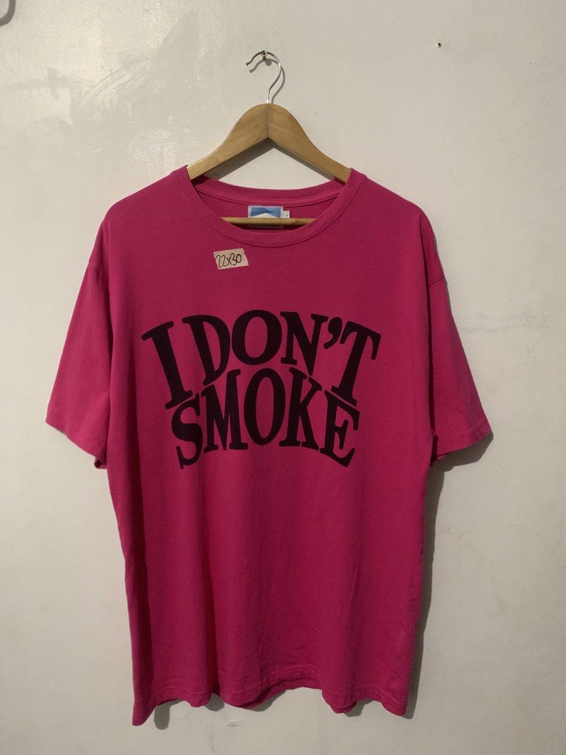 Donsmoke "I DON'T SMOKE" Graphic Tee (Category: Tshirts & Polo Shirts ) located in Manila. Submitted by tanjames.14 (Listing ID 1461445575, Image 1). Description: - Pink graphic tee from Donsmoke - Features bold "I DON'T SMOKE" slogan - Made from 100% cotton - Tagged size L - Care instructions available on label - Perfect statement piece.
