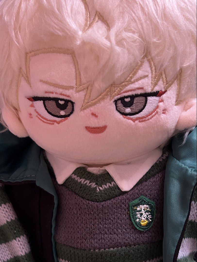Draco Malfoy Plush Doll (Category: Plushies & Soft Toys) located in Bulacan. Submitted by declutteringthing_s (Listing ID 1461433070, Image 2). Description: Only used for display Bought for 2k - Adorable plush doll inspired by Draco Malfoy. - Features a detailed Slytherin uniform: sweater, tie, scarf, and robe. - Embroidered facial details for a charming look. - Scarf proudly displays Slytherin colors and crest.