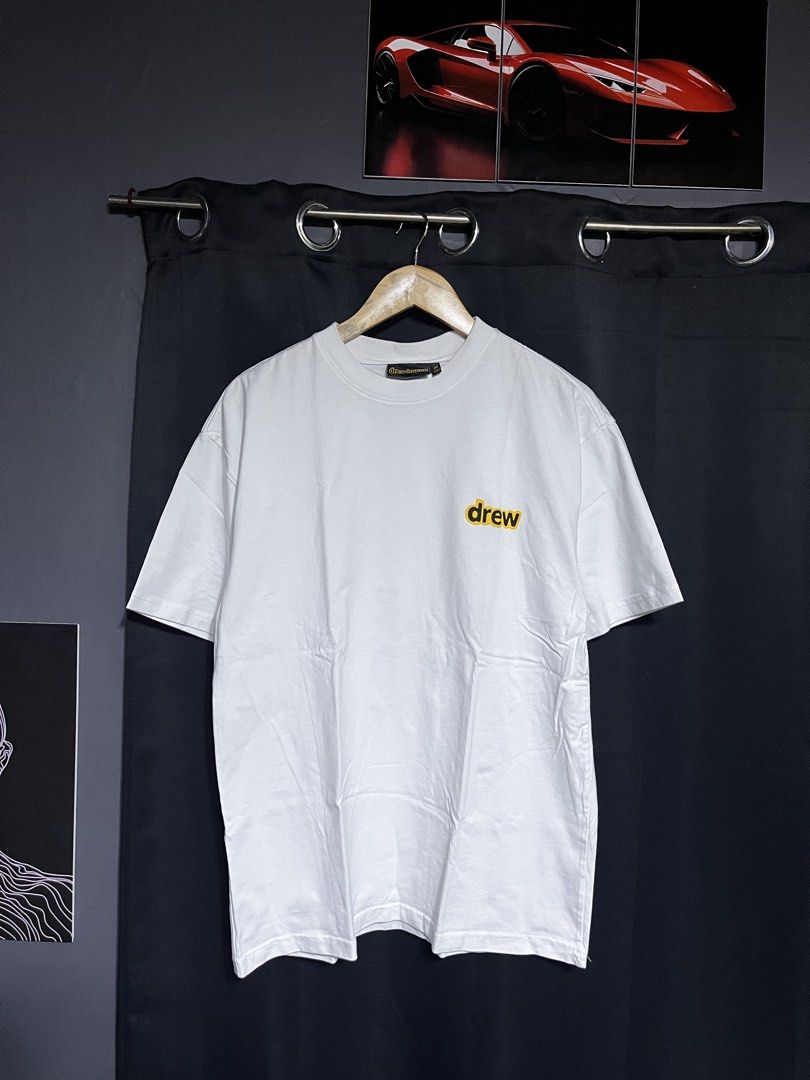 Drew House White T-Shirt Size M (Category: Tshirts & Polo Shirts ) located in Panabo. Submitted by edition_25 (Listing ID 1461540200, Image 1). Description: - White Drew House T-shirt - Iconic 'drew' logo on front left chest - Fun graphic print with clouds and characters on the back - Size: Medium (M) - Made in Vietnam - Ideal for casual everyday wear - 22 width - 30 length - As new condition .