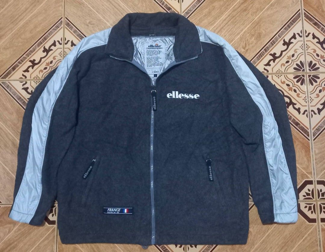 Ellesse Fleece Jacket with Light Grey Accents (Category: Coats, Jackets and Outerwear) located in Baguio. Submitted by jiannisthriftfits (Listing ID 1461560671, Image 1). Description: - Ellesse grey fleece jacket - Size L - Light grey accents on sleeves and collar - Full zip closure - Pockets included - Shiny inner lining - Small France patch on the front.