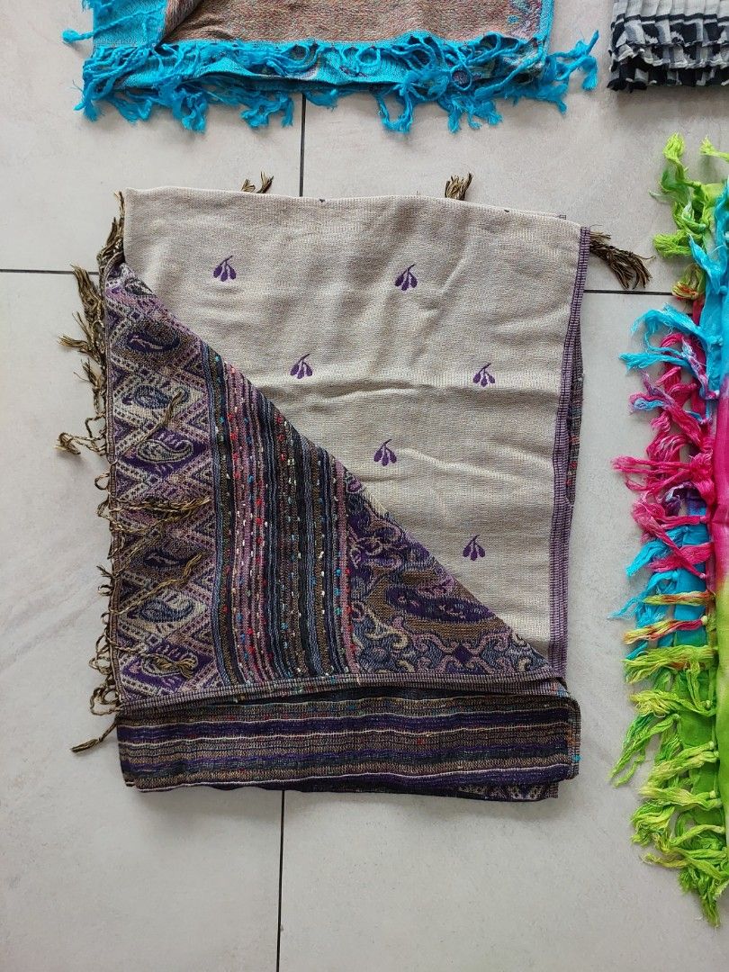 Embroidered Paisley Shawl with Tassels (Category: Scarves) located in Caloocan City. Submitted by ericajane_tc (Listing ID 1461407996, Image 1). Description: - Neutral base with purple floral embroidery - One side features vibrant paisley pattern with striped borders and tassels - 100% Pashmina Size: 68 inch x 27 inch.